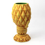 Yellow pineapple-shaped mug on a white background